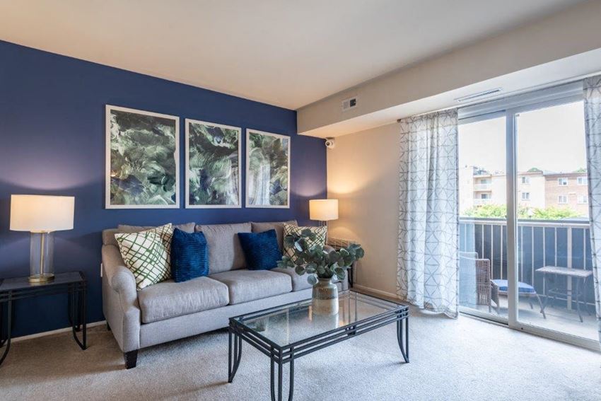 a living room with a couch and a glass table