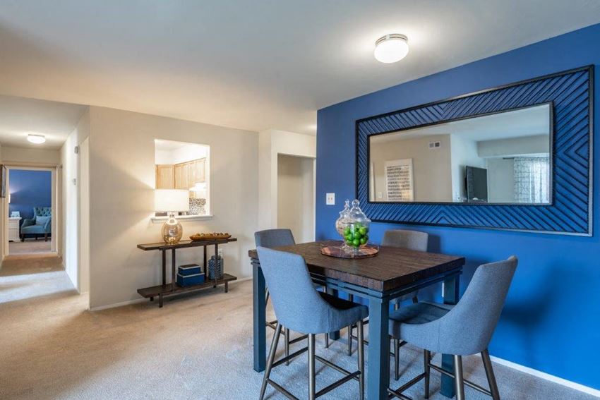 a dining room with a large mirror and a table with chairs