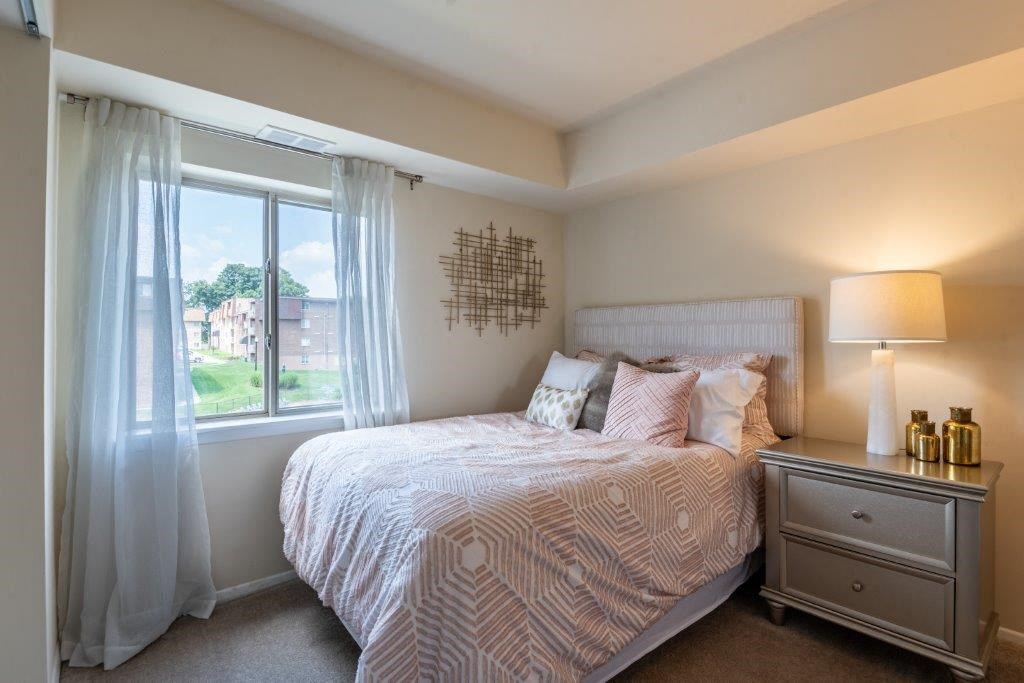 a bedroom with a bed and a window