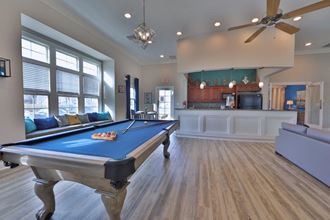 a pool table in the middle of a living room