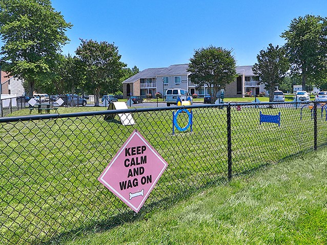 a keep calm and was on sign on a chain link fence