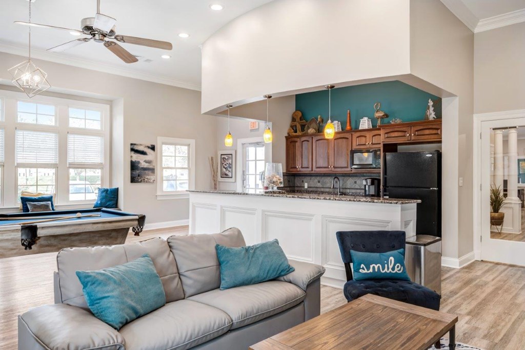 A living room with a grey couch and a wooden coffee table.
