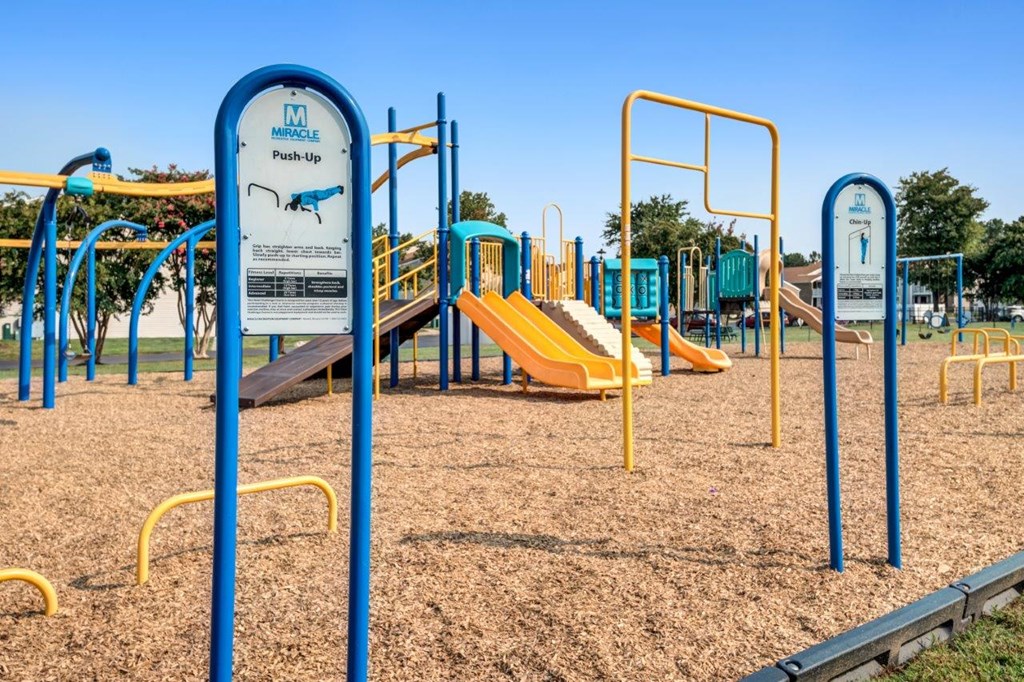 A playground with a push-up station and a slide.