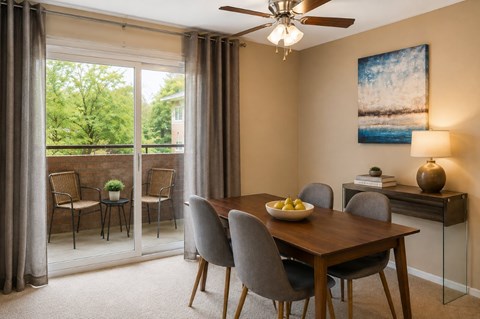 A dining room with a table set for four.