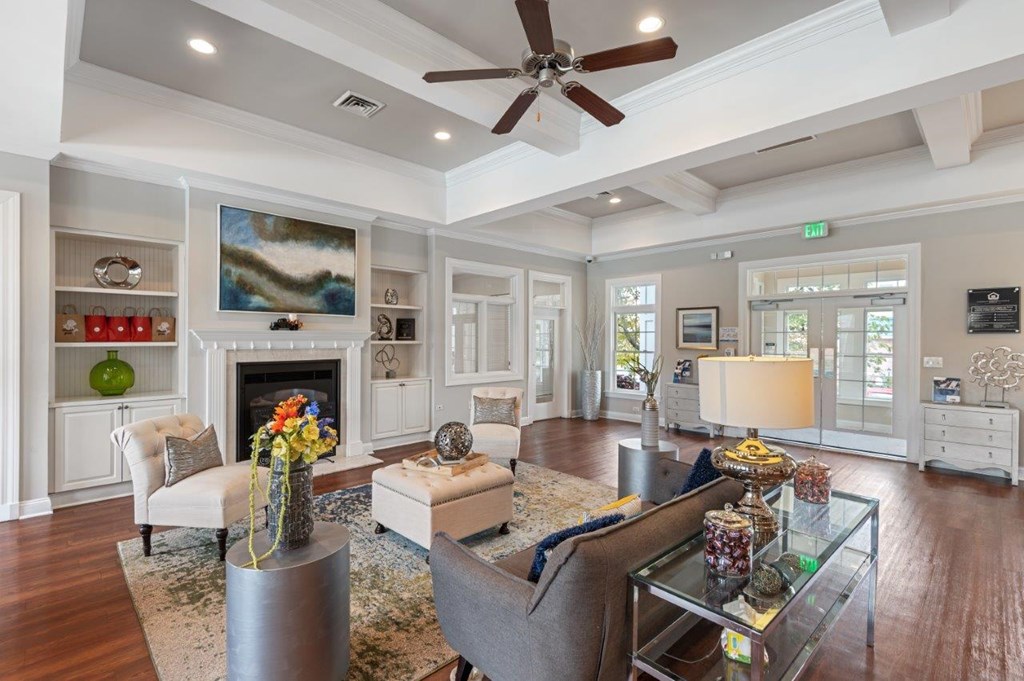 A living room with a fireplace and a painting on the wall.
