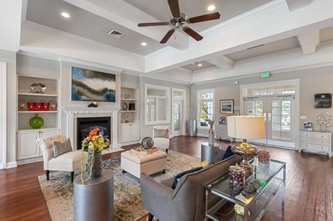 A living room with a fireplace and a painting on the wall.