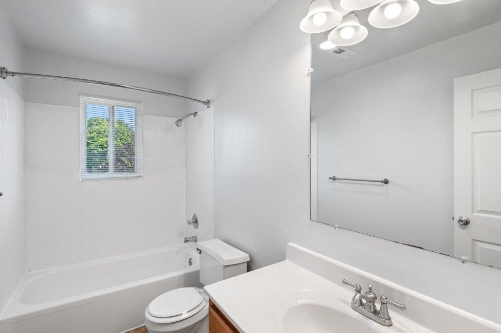 a bathroom with a sink toilet and a mirror