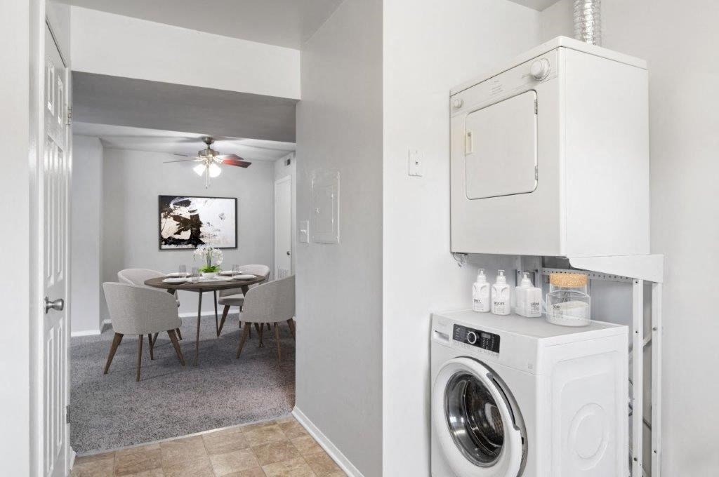 a white laundry room and dining room with a washing machine