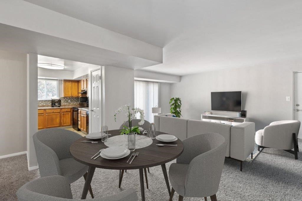 a living room with a table and chairs and a television