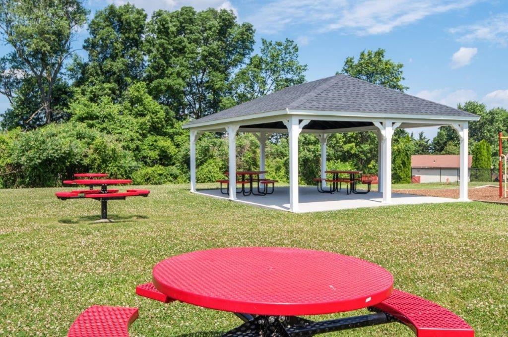 a picnic area with a pavilion and tables