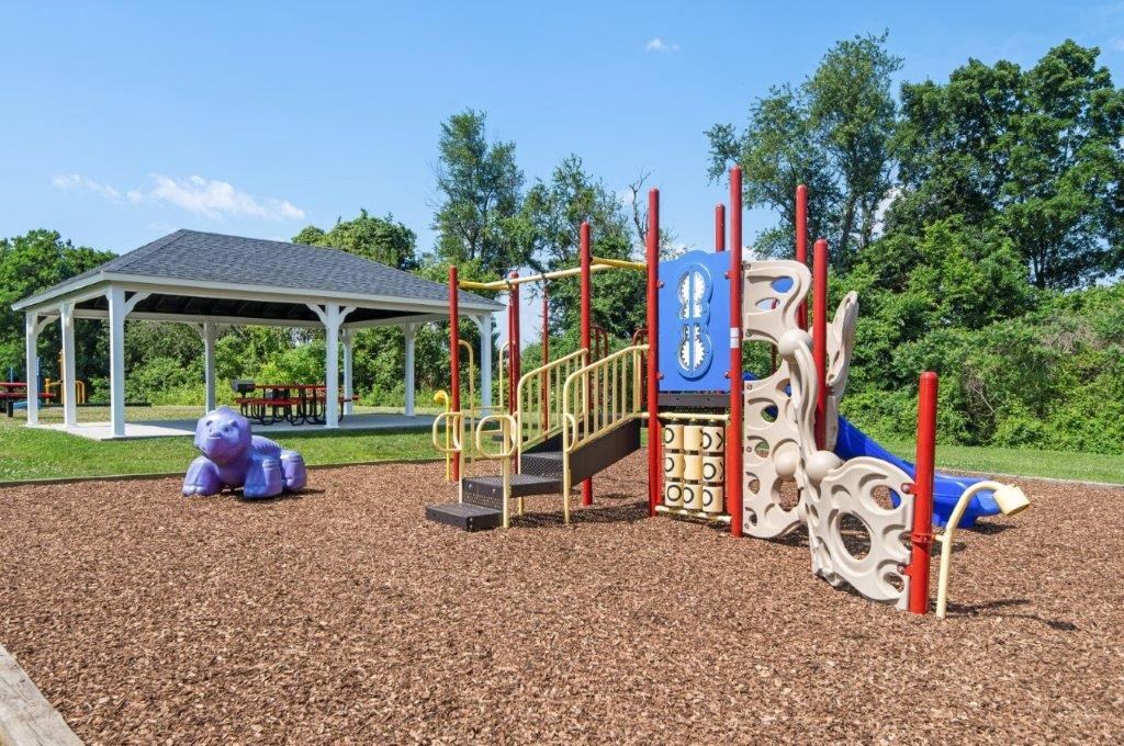 a playground with a pavilion in the background