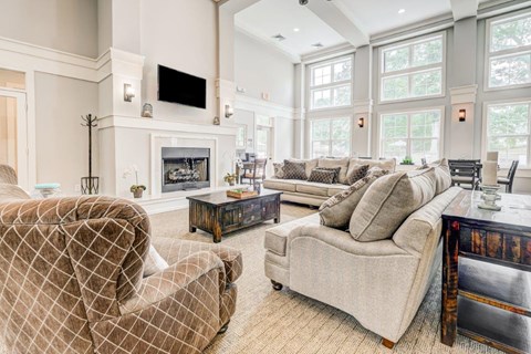 a living room with couches and chairs and a fireplace