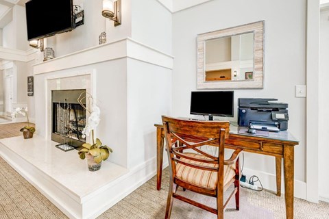 a home office with a desk and a fireplace
