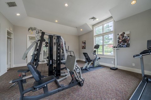 a home gym with exercise equipment and a window
