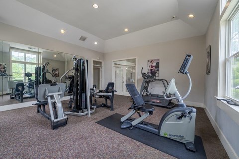 a gym with treadmills and other exercise equipment in a home