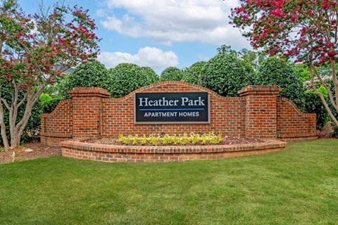 the sign is in front of a brick wall