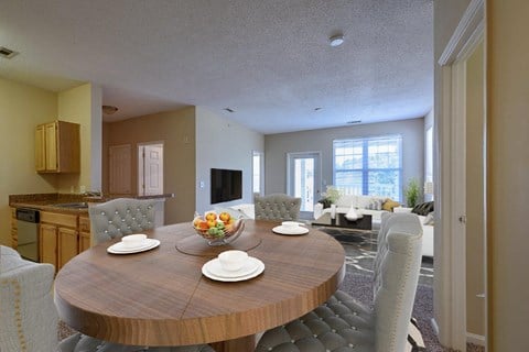 a dining room and living room with a table and chairs