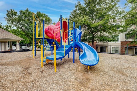 A playground with a blue and red slide.
