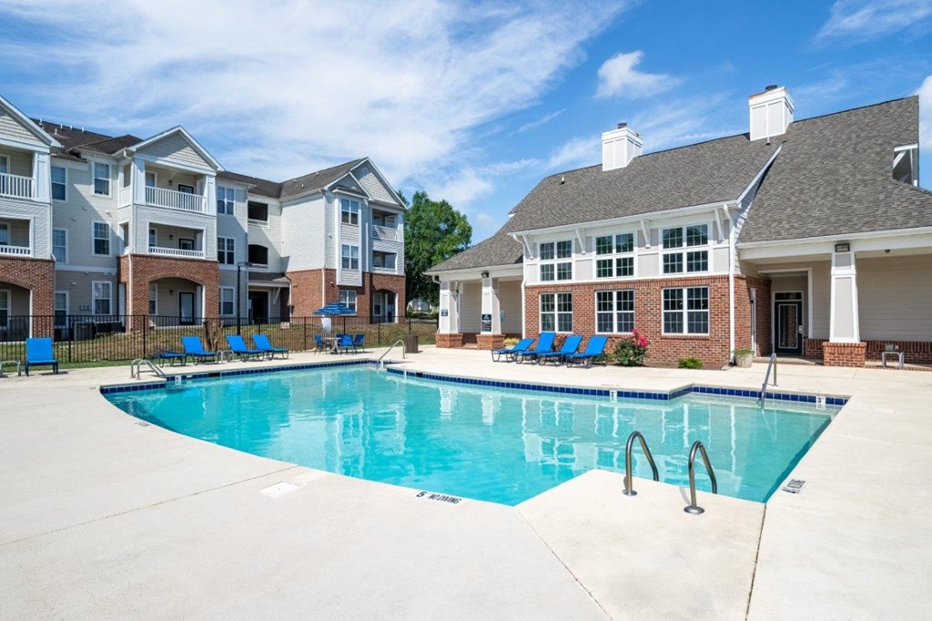 A swimming pool in front of apartment buildings.