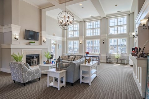 A living room with a fireplace and a television on the wall.