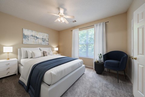 A bedroom with a large bed, a chair, and a painting on the wall.