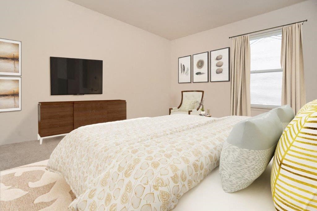 a bedroom with a bed and a tv in it