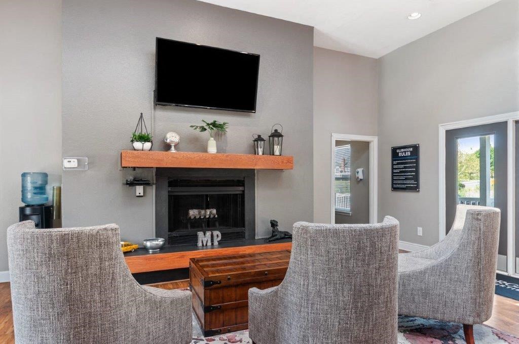 a living room with a fireplace and a tv on the wall