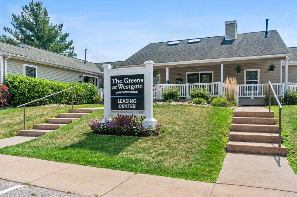 the greens at waverly apartments sign in front of building