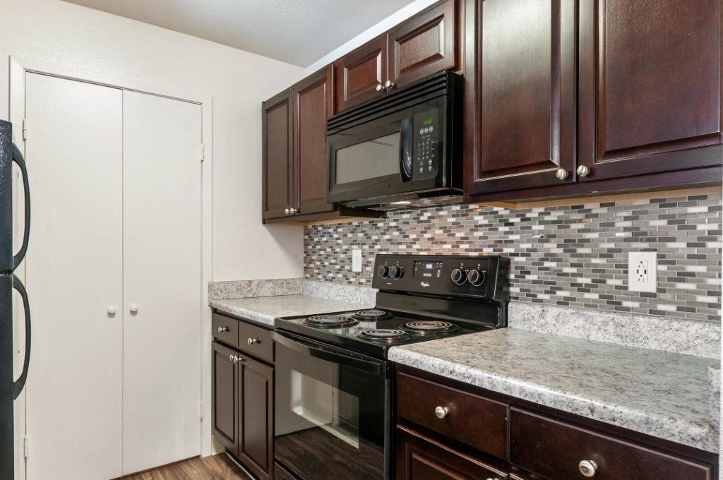 a kitchen with a stove and a microwave