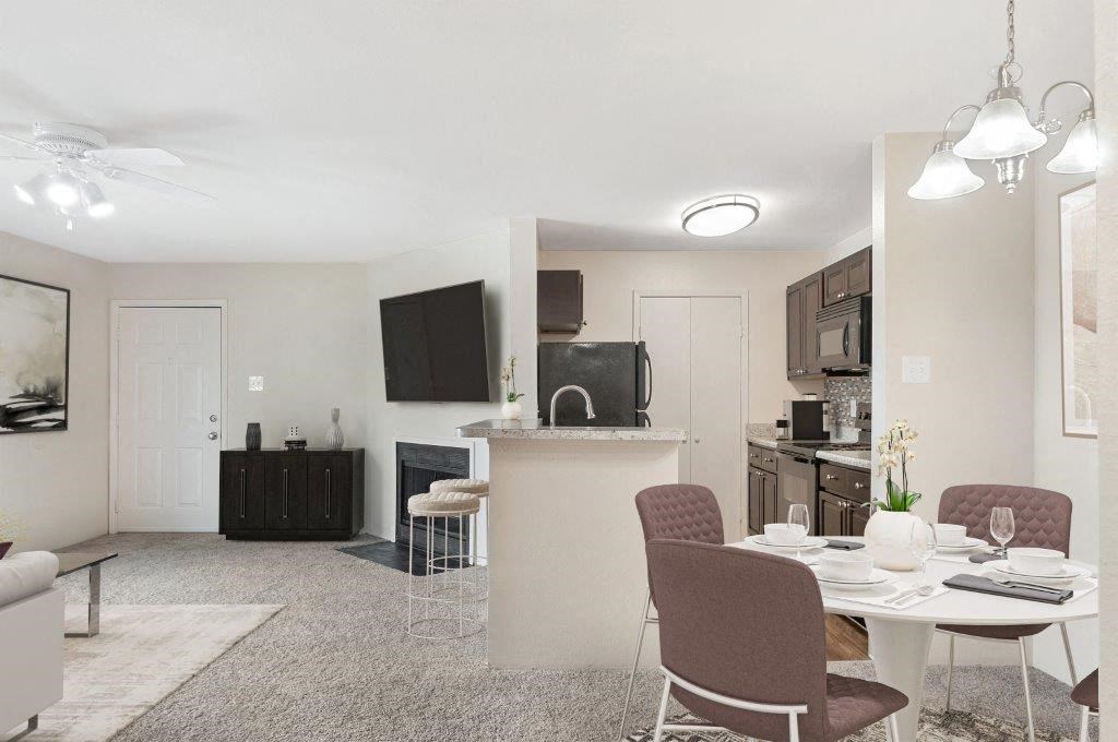 a living room and kitchen with a table and chairs