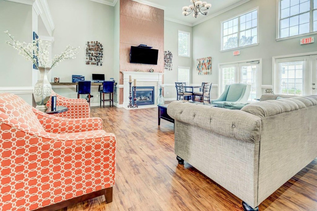 a living room with couches and chairs and a fireplace