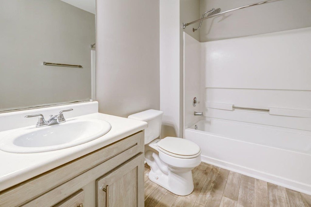 an empty bathroom with a sink toilet and shower