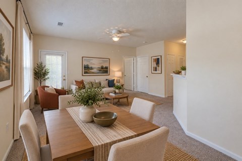A dining room with a wooden table and chairs.