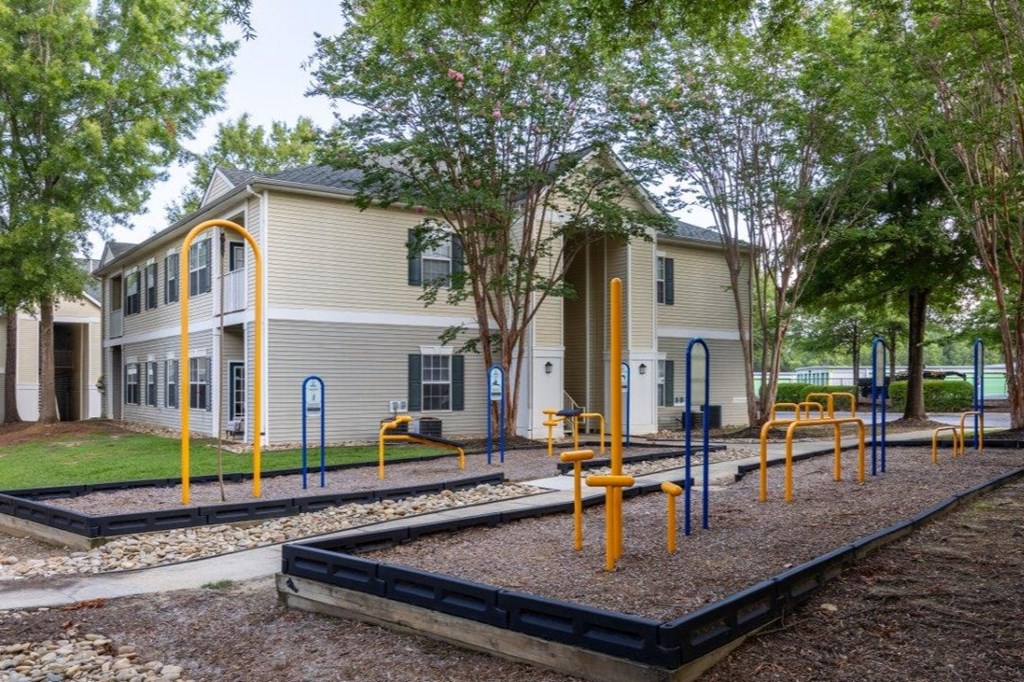 a playground in front of a yellow school building