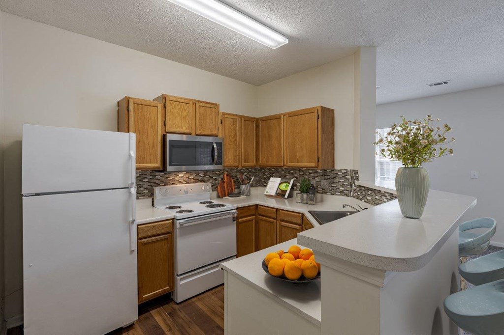 a kitchen with white appliances and wooden cabinets