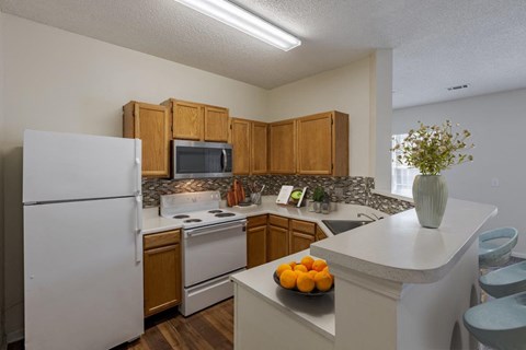 a kitchen with white appliances and wooden cabinets