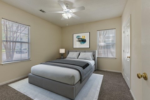 a bedroom with a bed and a ceiling fan