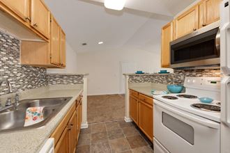 a kitchen with a stove top oven and a sink