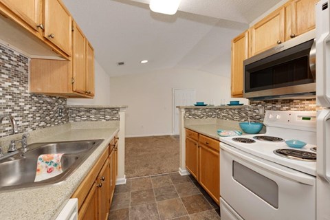 a kitchen with a stove top oven and a sink
