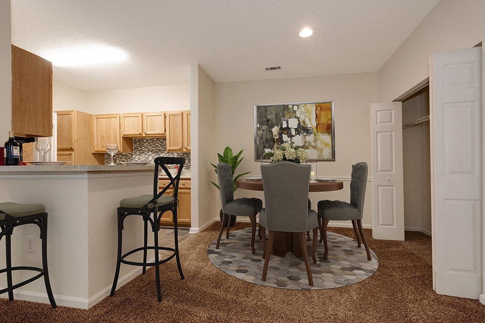 an open kitchen and dining room with a table and chairs