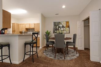 an open kitchen and dining room with a table and chairs