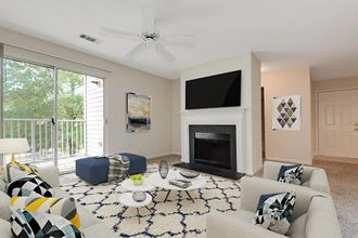 a living room with a white couch and a fireplace