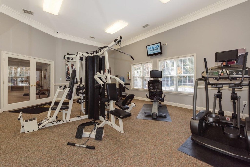 a gym with weights and cardio equipment in a home gym