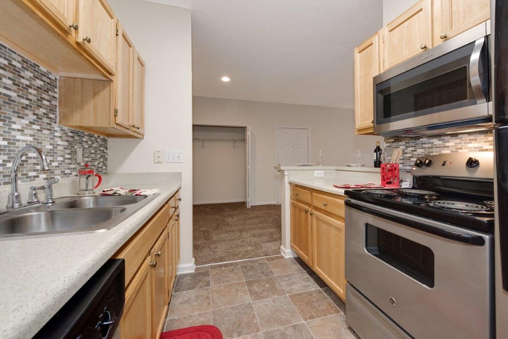 a kitchen with stainless steel appliances and wooden cabinets
