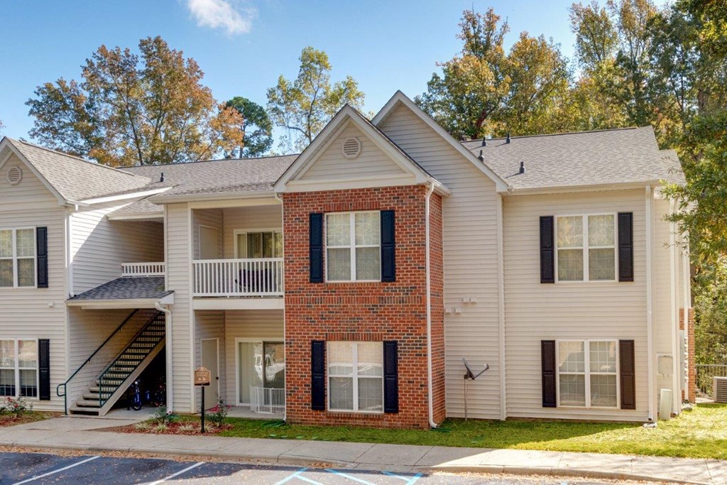 exterior view of an apartment building with brick and white siding