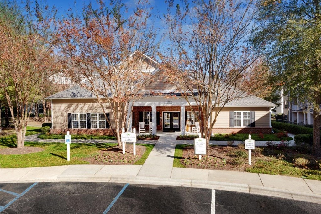 the front of a house with signs in front of it