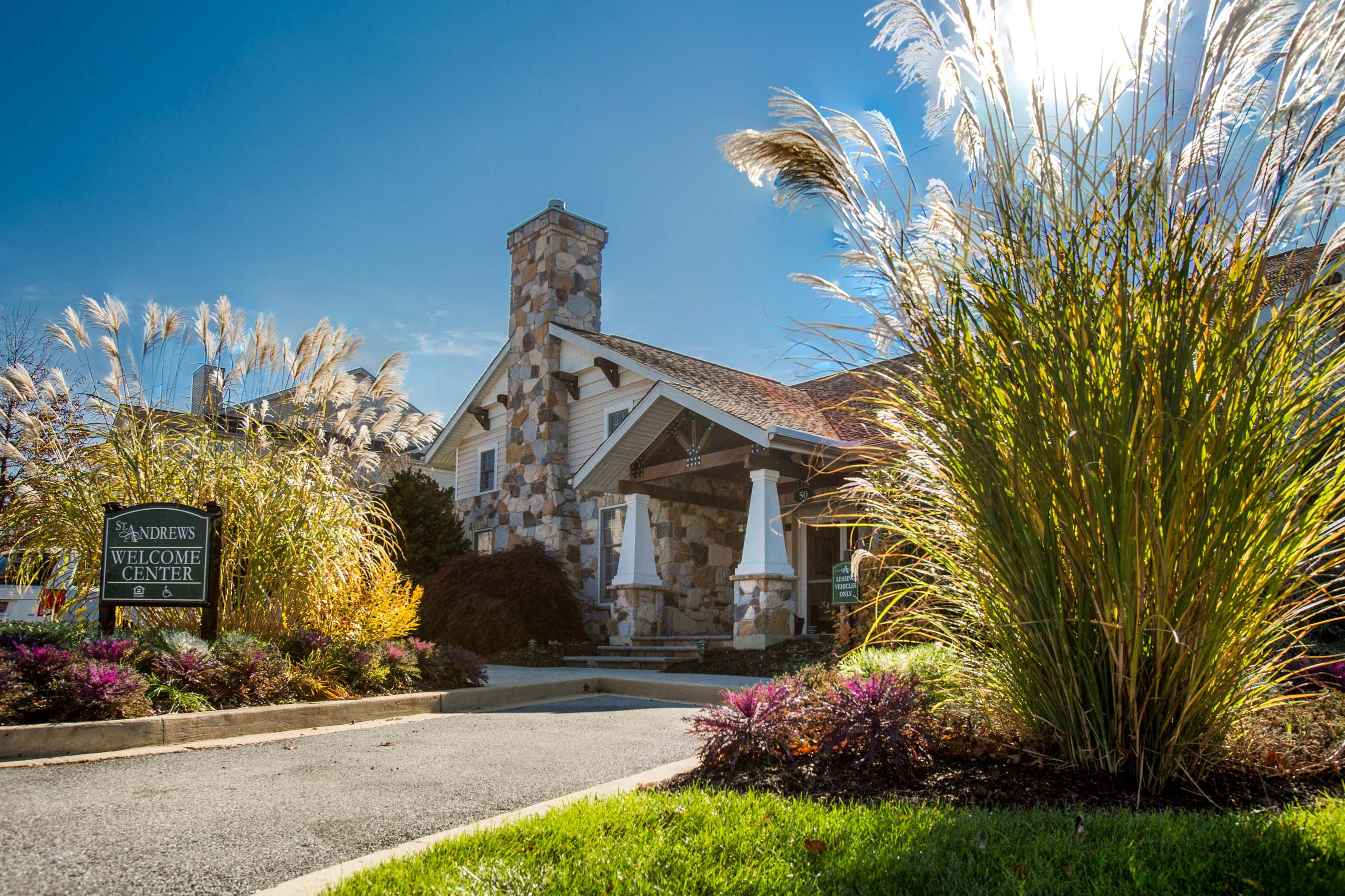 a house with a driveway and a sign in front of it