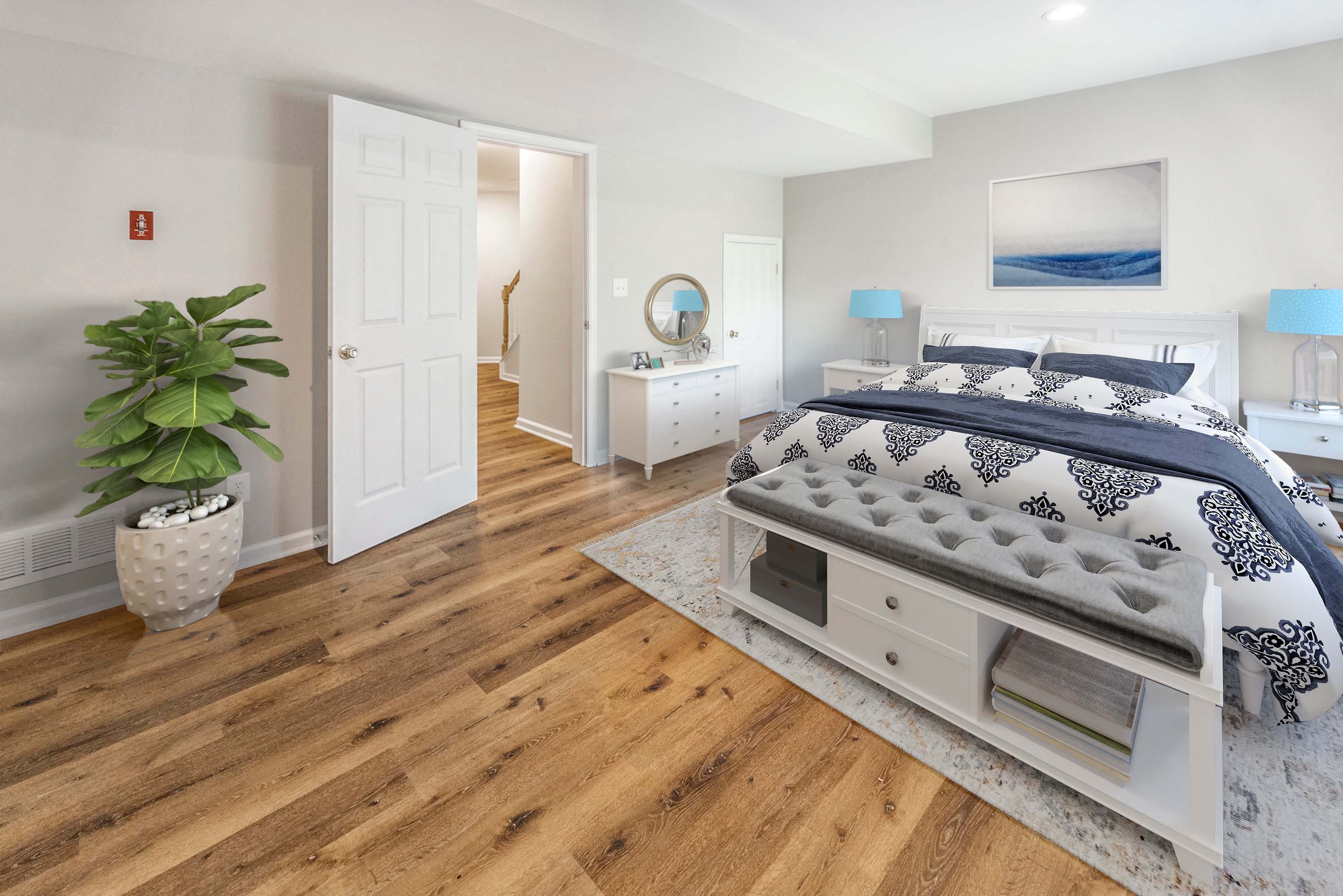 a bedroom with a bed and a potted plant