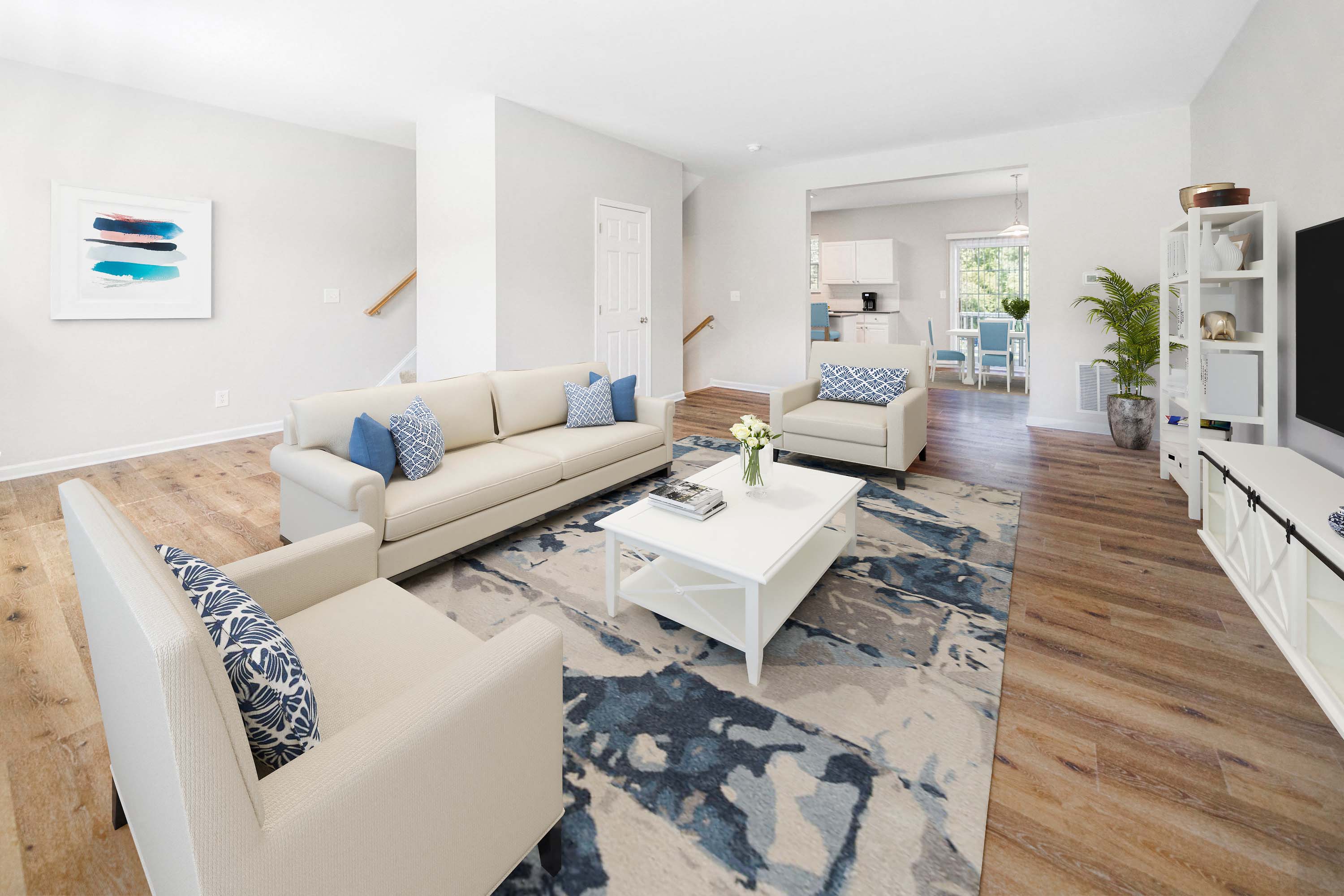 a living room with white couches and a coffee table