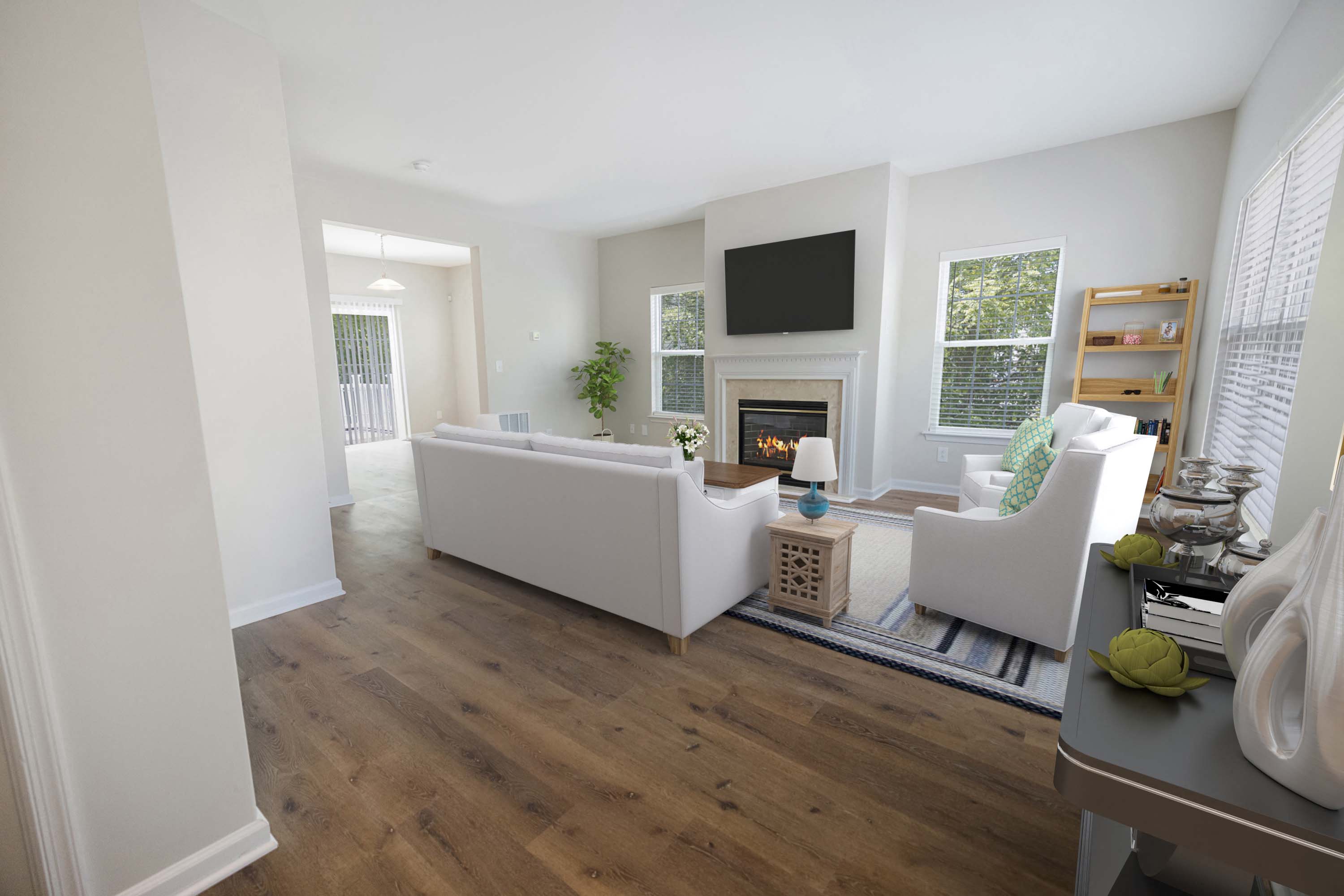 a living room with white furniture and a fireplace